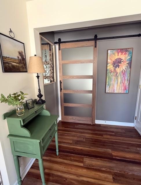 Green painted secretary desk beside a sliding barn door