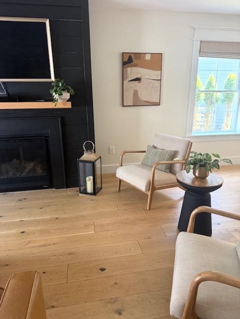 Pair of oak armchairs beside the fireplace